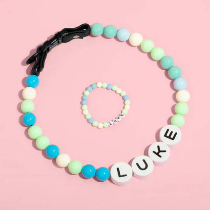 Personalized pet name necklace with matching bracelet from MadeMine, featuring custom pet name pendants in silver with delicate chain links.