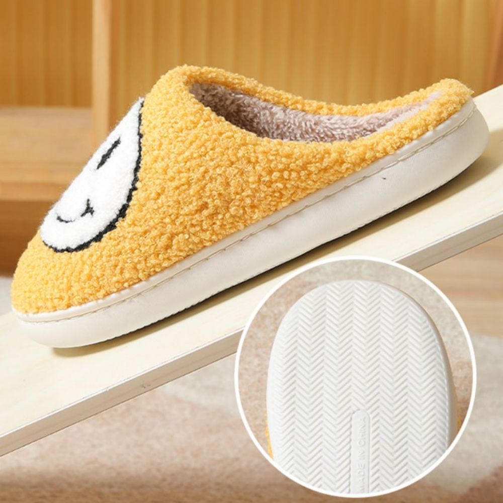 Fuzzy smiley face cotton slippers by MadeMine, warm and cozy house slippers for women and men with fluffy, soft texture.