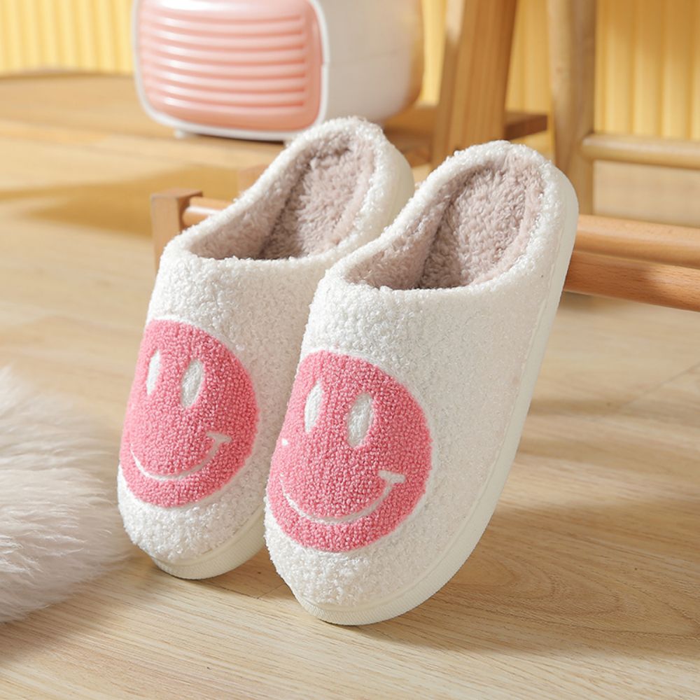 MadeMine smiley face cotton fuzzy slippers with fluffy warmth, cozy house slippers for women and men on soft surface.