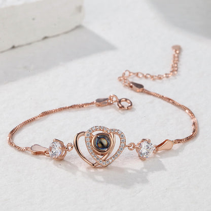Custom double heart projection bracelet made of 925 sterling silver by MadeMine, featuring intricate heart designs and polished finish.